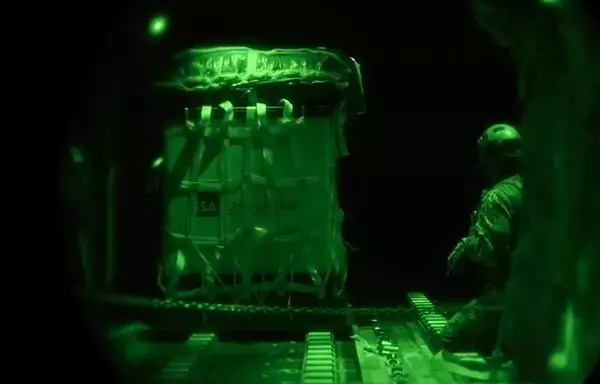 An aircrew member performs an airdrop out of an HC-130 in 2021. [US Air Force]