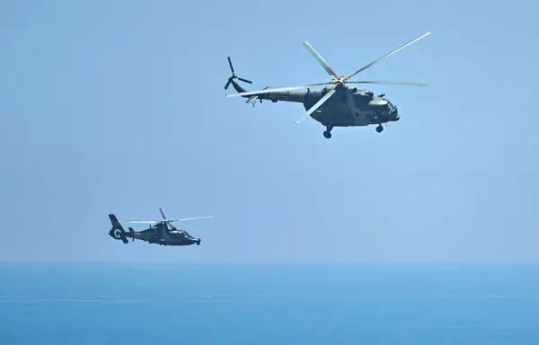 Chinese military helicopters fly past Pingtan island, one of mainland China's points closest to Taiwan, in Fujian province on August 4, ahead of massive military drills off Taiwan, in a show of force straddling vital international shipping lanes. [Hector Retamal/AFP]