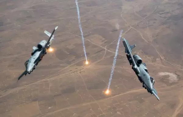 Two A-10s releasing countermeasures. [US Air Force]