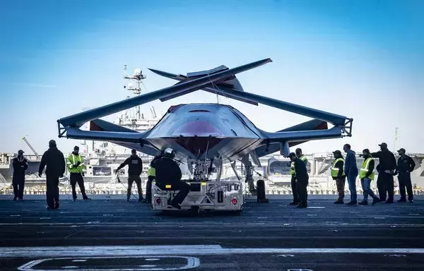 Sailors and Boeing team members prepare to move an unmanned MQ-25 Stingray aircraft into the hangar bay of the aircraft carrier USS George H.W. Bush in Norfolk, Virginia, November 30, 2021. The MQ-25 is the world's first operational, carrier-based unmanned aircraft. [US Defence Department]