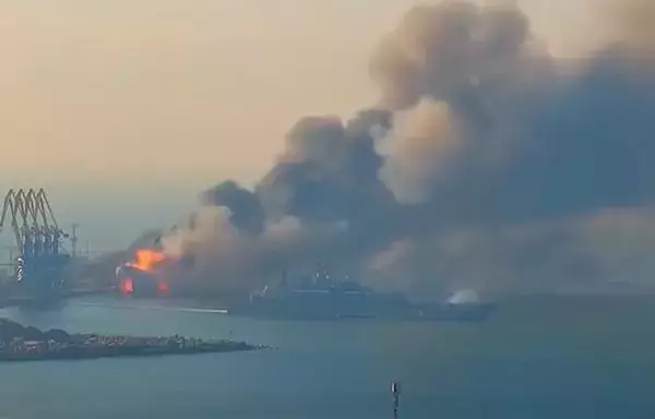 A screenshot from a video circulated on social media shows flames and smoke rising from the Russian ship Saratov, an Alligator-class tank landing ship, on March 24, 2022, as another Russian warship is seen hastily putting to sea to escape the inferno. The Saratov sank in Berdyansk, Ukraine.
