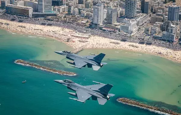 Two F-16s fly over anniversary celebrations off the coast of Israel on April 26. [Israeli Air Force]