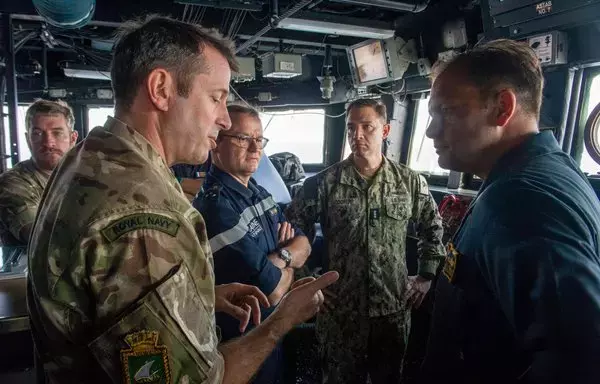 From left to right, UK Maritime Component Commander Commodore Philip Dennis, Joint Commander of the French Forces Deployed in the Indian Ocean Vice Adm. Emmanuel Slaars, Vice Adm. Brad Cooper, commander of US NAVCENT, and Cmdr. Jake Ferrari, commanding officer of guided-missile destroyer USS Paul Hamilton, discuss maritime operations aboard the Paul Hamilton while transiting the Strait of Hormuz May 19. [US Navy]