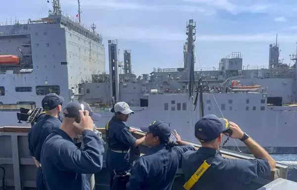 Sailors aboard the guided-missile destroyer USS Paul Hamilton monitor a replenishment-at-sea with the dry cargo and ammunition ship on May 18 in the Gulf. [US Navy]
