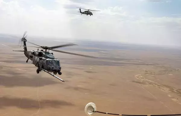 Two HH-60G Pave Hawks prepare to refuel from an HC-130J Combat King II during an exercise at an undisclosed location over Southwest Asia, May 30. [US Air Force]