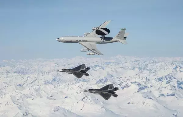 An E-3 Sentry and F-22 Raptors fly over Alaska May 5, 2020. [US Air Force]
