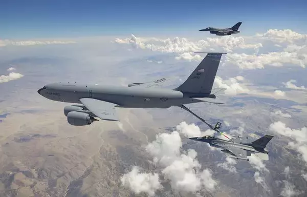 An F-16 Fighting Falcon receives air-to-air refuelling from a KC-135 Stratotanker last July 19. [US Air Force]
