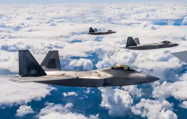 Three US Air Force F-22 Raptors fly alongside a US Air Force KC-135 Stratotanker over Poland on August 10. [US Air Force]