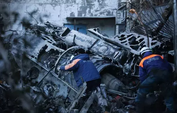 Russian Emergencies personnel remove the wreckage of a Sukhoi Su-34 military jet from its crash site in the courtyard of a residential area in the town of Yeysk in southwestern Russia on October 18. Russia said a 'technical malfunction' probably caused a jet to crash into a block of flats in Yeysk, near Ukraine. [AFP]