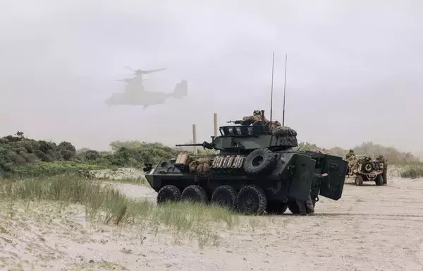 A US Marine Corps light armored vehicle with the 26th Marine Expeditionary Unit provides security for aerial insertion while executing an amphibious assault during a composite training unit exercise at Camp Lejeune in North Carolina June 2. [US Marine Corps]