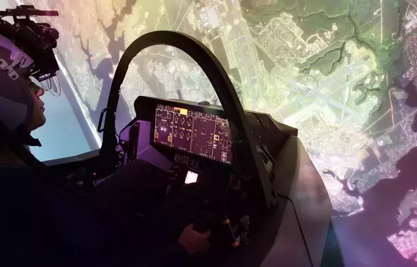 A pilot sits inside an F-35 training system. [Lockheed]