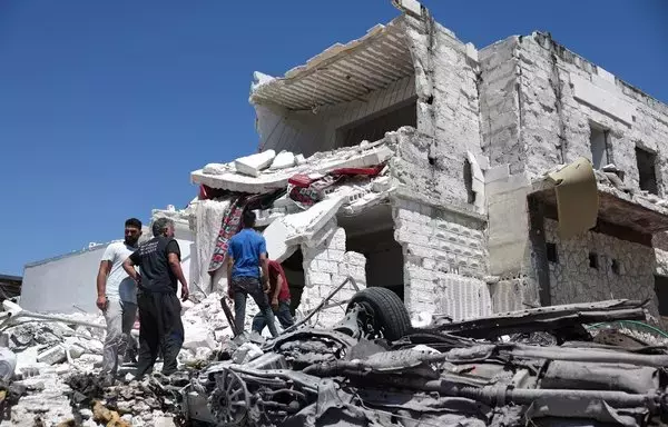 Men inspect the rubble of a house following reported Russian air strikes on the western outskirts of Idlib city, Syria, on August 5. At least three civilians from the same family were killed. [Omar Haj Kadour/AFP]