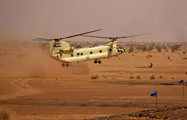 An Egyptian air force CH-47 Chinook helicopter hovers above the ground during the 'Guardians of the Nile' joint military drill between Egypt and Sudan in the Um Sayyala area, northwest of Khartoum, on May 31, 2021. [Ashraf Shazly/AFP]