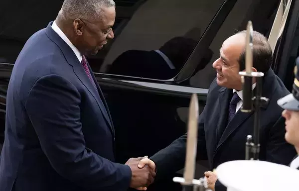 US Secretary of Defense Lloyd Austin greets Egyptian President Abdel Fattah al-Sisi (R) as he arrives for meetings at the Pentagon on December 14. [Saul Loeb/AFP]