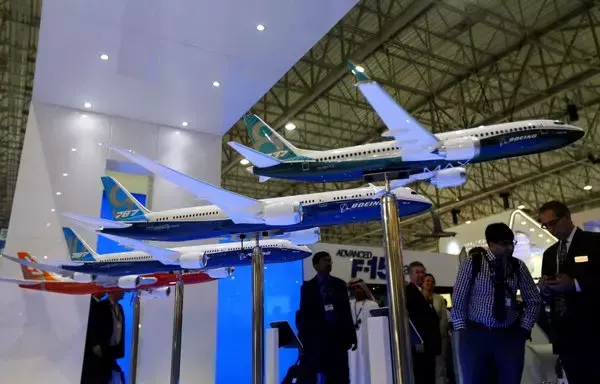 Various models of Boeing aircraft are displayed during the Dubai Airshow on November 17, 2013, in Dubai, UAE. That year, Emirates Airlines purchased 150 Boeing 777X planes and 50 Airbus A380s for $99 billion. [Marwan Naamani/AFP]