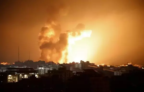 Fire and smoke rise above buildings during an Israeli air strike in Gaza on October 8. At least 200 Israelis died in a surprise large-scale attack by the Palestinian militant group Hamas on October 7, the army said. [Eyad Baba/AFP]