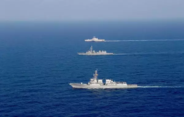 An Arleigh Burke-class guided-missile destroyer and an Independence-variant littoral combat ship conduct joint operations with a Japan Maritime Self-Defense Force destroyer in the South China Sea on October 17. [US Navy]