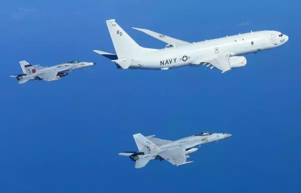 F/A-18E Super Hornets intercept and escort a P-8A Poseidon maritime patrol aircraft during a multinational exercise on August 9 in the central Mediterranean Sea. [US Navy]