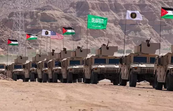 A parade of High Mobility Multipurpose Wheeled Vehicles with the Saudi, Jordanian and US flags enters the exercise area at the end of the Eager Lion 22 final exercise at the Royal Jordanian Naval Base in Jordan on September 11, 2022. [US Marine Corps]