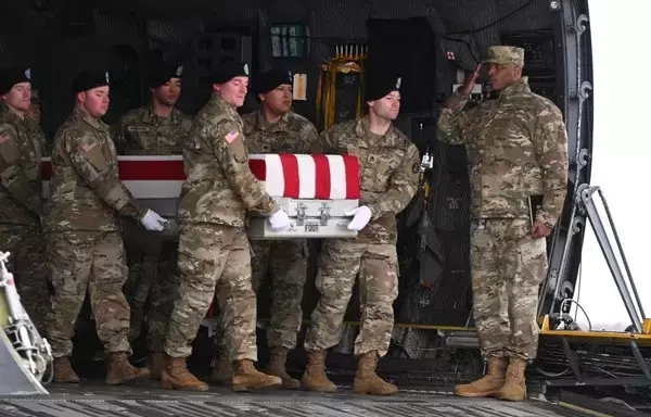 A transfer case is unloaded on February 2 during the dignified transfer ceremony of the remains of three US service members killed in the drone attack on the US military outpost in Jordan. [Roberto Schmidt/AFP]