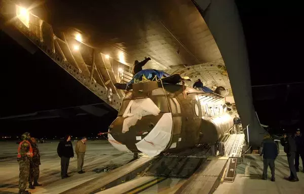 A US Army CH-47 Chinook helicopter is loaded onto a C-17 Globemaster III, at Naval Station Rota in Spain. [US Air Force]