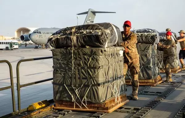 Military personnel load humanitarian aid into a plane ahead of a joint US-Jordanian airdrop into Gaza. [CENTCOM]
