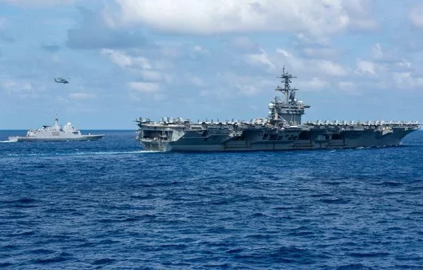 The USS Theodore Roosevelt sails alongside the French Aquitaine-class frigate FS Bretagne on June 7. [US Navy]