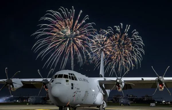 Fireworks explode behind a C-130J Super Hercules during Celebrate America at Yokota Air Base in Japan July 4. [US Air Force]