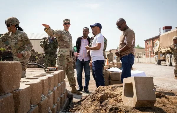 A US Army captain explains the planning phases of construction projects to engineer officers of the Djibouti Armed Forces (DAF) at Camp Dodge, Iowa, May 15. The DAF visited the Kentucky Army National Guard to learn how to set up battalion-level engineer operations. [US Army]