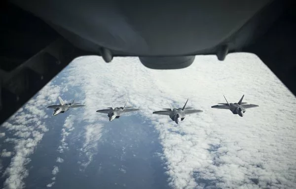 F-22 Raptors fly in formation after being refueled by a KC-10 during a 2017 exercise. [US Air Force]