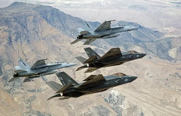 F-35C Lightning IIs and F/A-18E/F Super Hornets fly in formation. [US Navy]