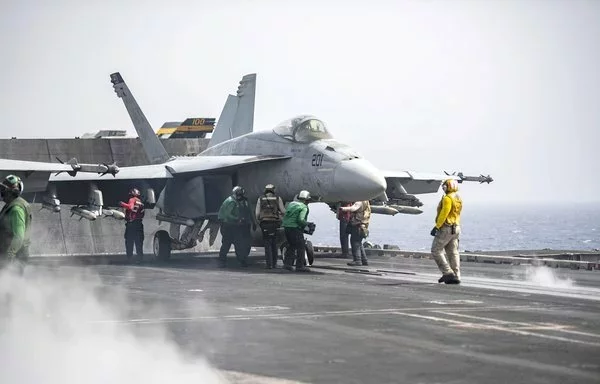 Sailors prepare an F/A-18E Super Hornet for launch aboard the Nimitz-class aircraft carrier USS Dwight D. Eisenhower in the Red Sea, April 19. [US Navy]