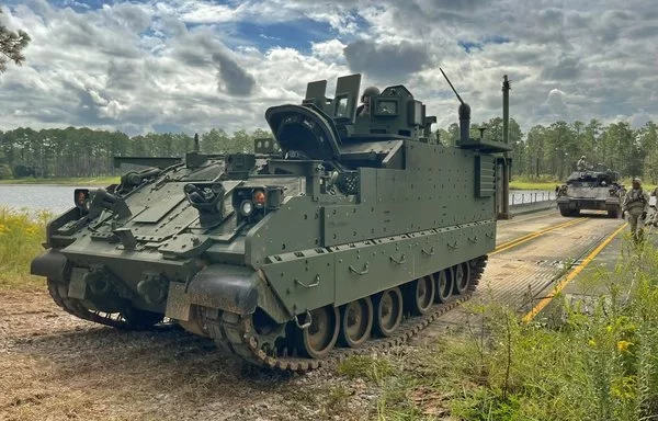 An Armored Multipurpose Vehicle drives off a barge during a wet-gap crossing exercise at Fort Stewart in Georgia last September 21. [US Army]