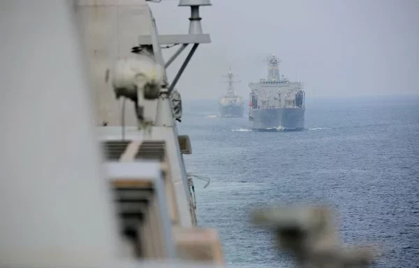 US warships sail in formation during a Strait of Hormuz transit. [US Navy]