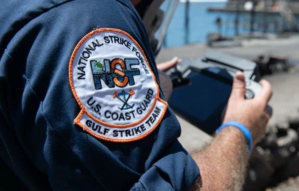 A member of the US Coast Guard National Strike Force Gulf Strike Team operates an unmanned aircraft system over Lahaina Harbor, Hawaii, last September 5. [US Coast Guard]