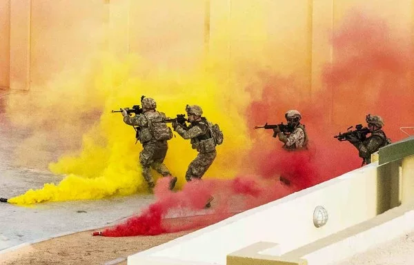 US and Emirati troops move through smoke to clear a simulated objective during Iron Union in the UAE, May 22, 2023. [US Department of Defense]