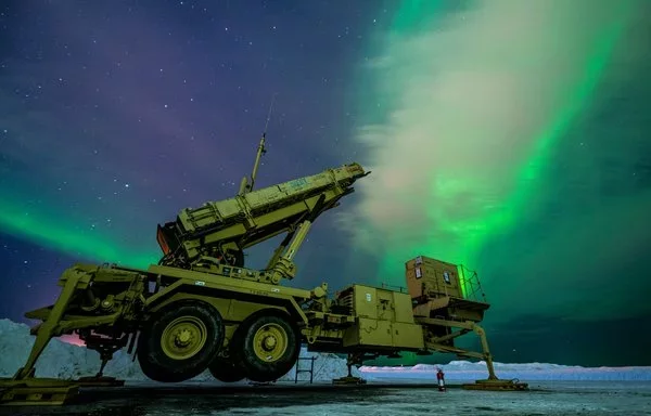 The northern lights glow behind an Army Patriot M903 launcher station at Eielson Air Force Base in Alaska March 5, 2022, during Exercise Arctic Edge 2022. [US Air Force]