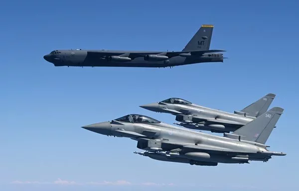 Two Royal Air Force Eurofighter Typhoons fly in formation with a U.S. Air Force B-52H Stratofortress within the US Central Command area of responsibility November 18. [US Air Force]