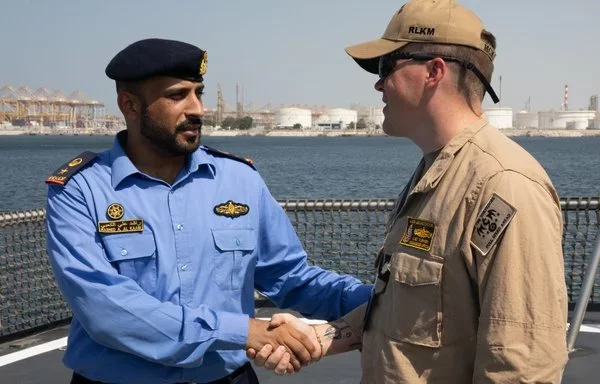 The commanding officer of the Avenger-class mine countermeasure ship USS Devastator welcomes a UAE officer aboard the ship during exercise Iron Defender 24 on October 14. [US Army]