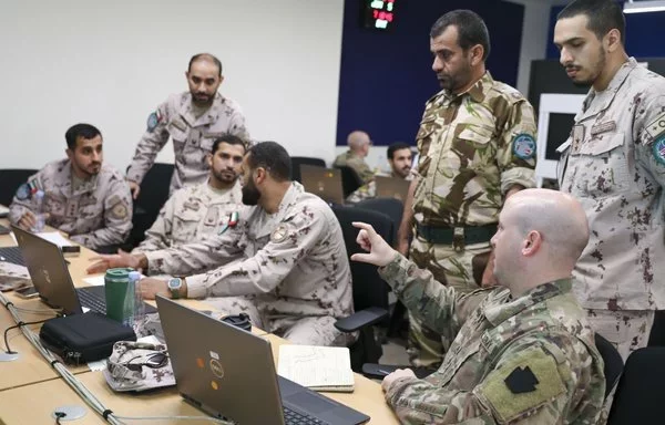 A US Army officer discusses strategies with service members from Oman and the United Arab Emirates during the command post exercise for Eagle Resolve in 2023 in Saudi Arabia. [US Army]