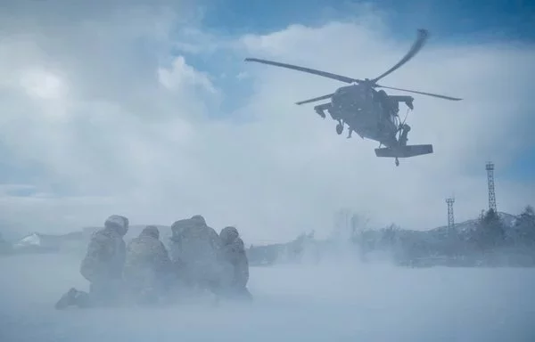 US soldiers prepare to connect a sling load to a UH-60 Black Hawk at Camp Makomanai, Japan, February 5. [US Marine Corps]